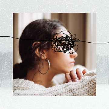 girl sitting in a sweater looking forlorn against snow girl sitting in a sweater looking forlorn against snow